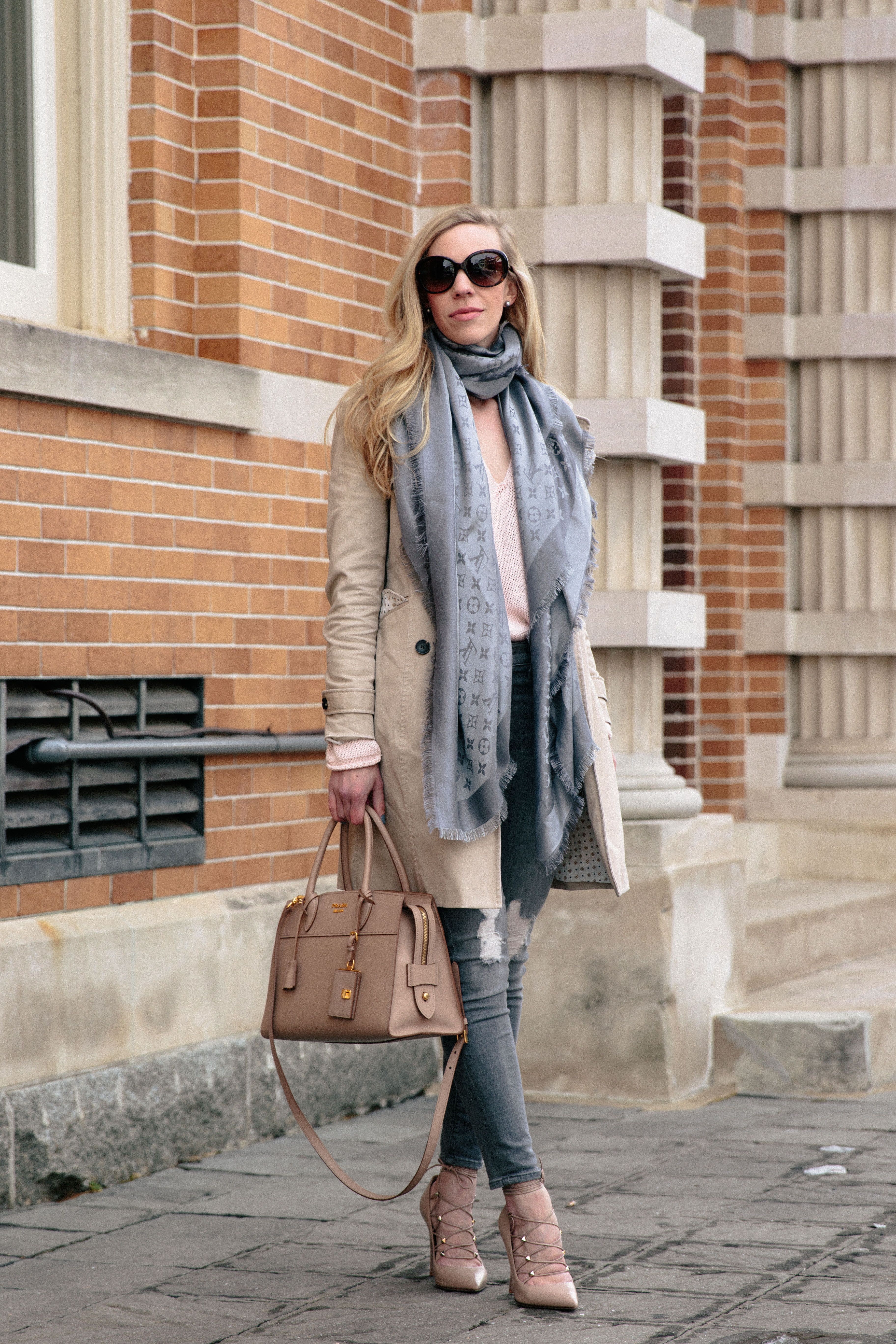 Meagan Brandon fashion blogger wears trench coat with pink sweater, gray  jeans, Louis Vuitton gray shine shawl scarf, Valentino nude Rockstud pumps  - Meagan's Moda