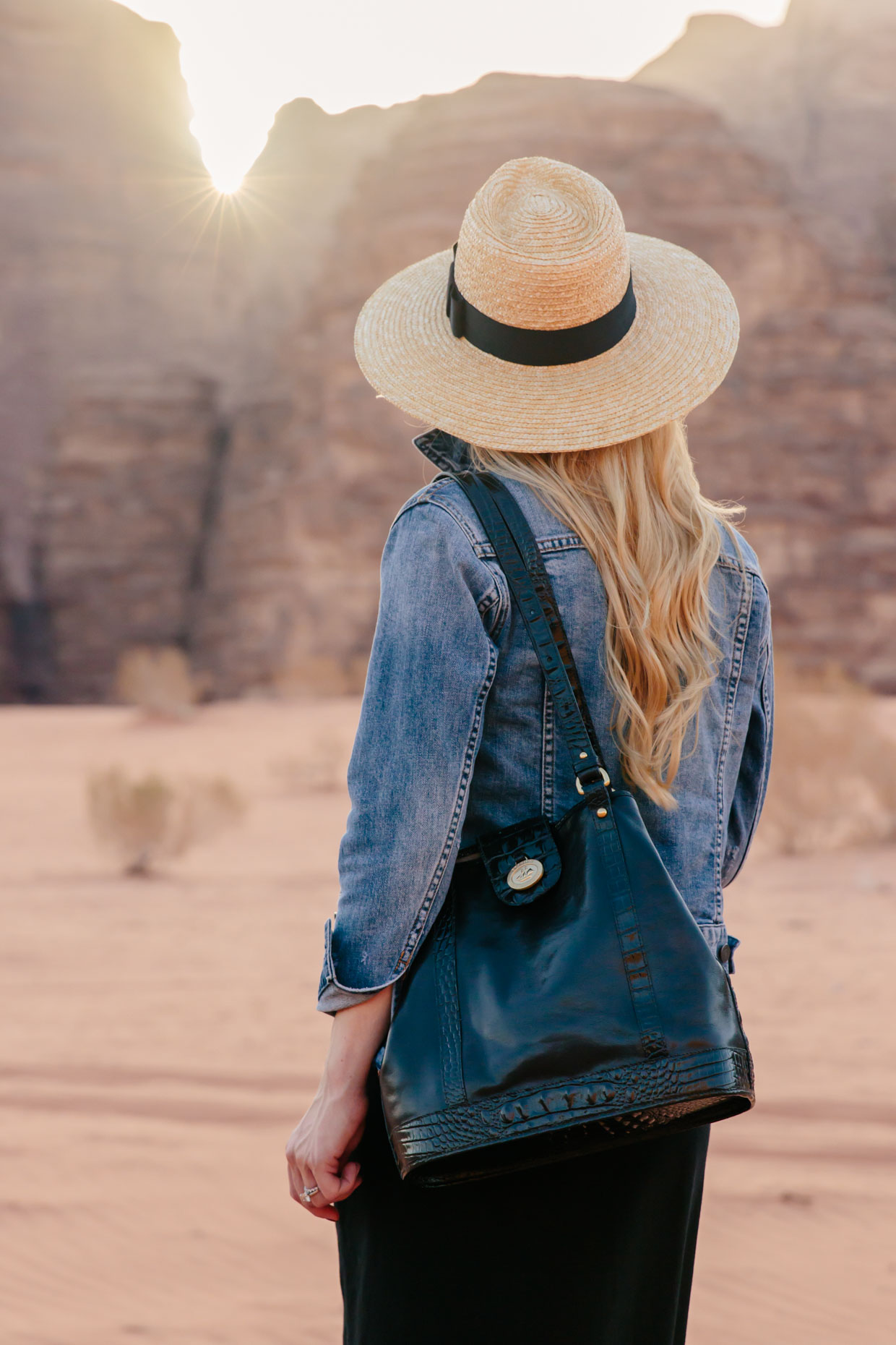 Meagan Brandon fashion blogger wearing denim jacket with Brixton Joanna straw hat and Brahmin Flower tote in Wadi Rum desert Jordan Meagan s Moda