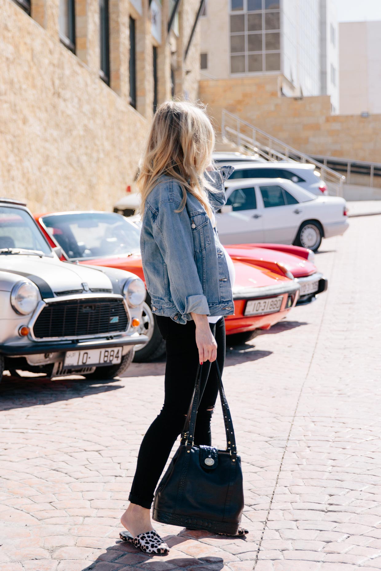 Meagan Brandon fashion blogger wearing Levi's ex-boyfriend trucker jacket  with black jeans and leopard print mules, Brahmin Flower bag - Meagan's Moda