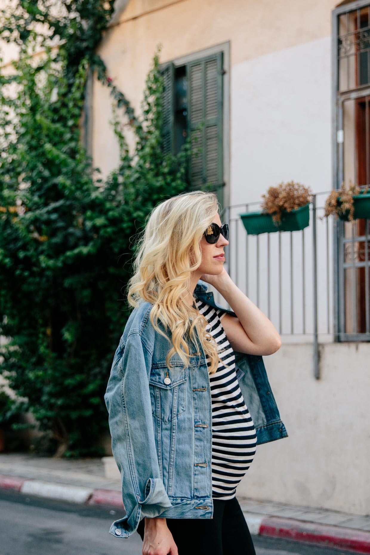Meagan Brandon fashion blogger wears Levi's ex boyfriend trucker jacket  with black and white striped tee, chic maternity outfit with denim jacket -  Meagan's Moda
