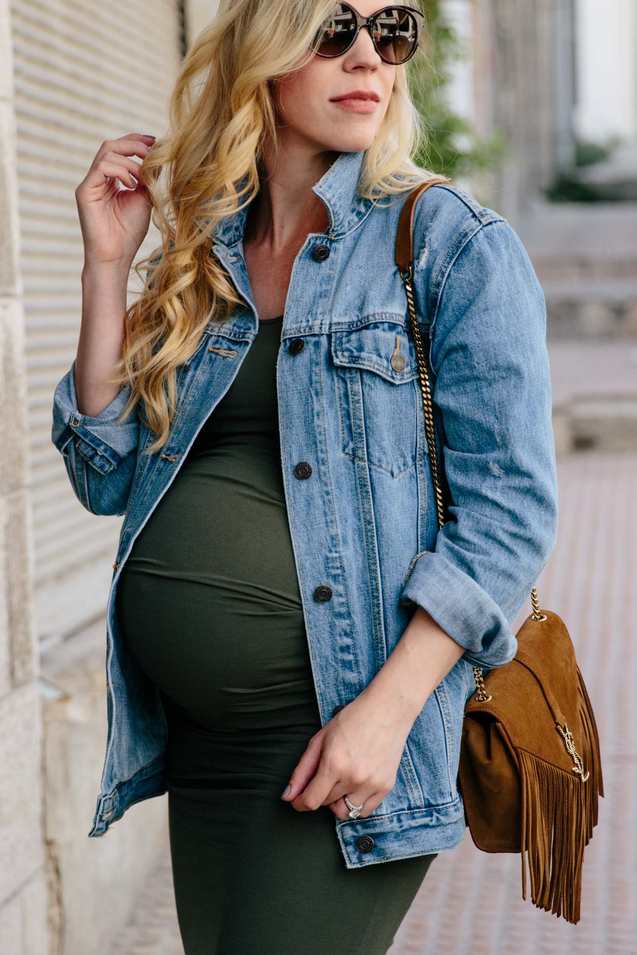 Meagan Brandon fashion blogger of Meagan s Moda wears oversized denim jacket with Ingrid and Isabel ruched maternity dress best maternity dress to fit all stages of pregnancy Meagan s Moda