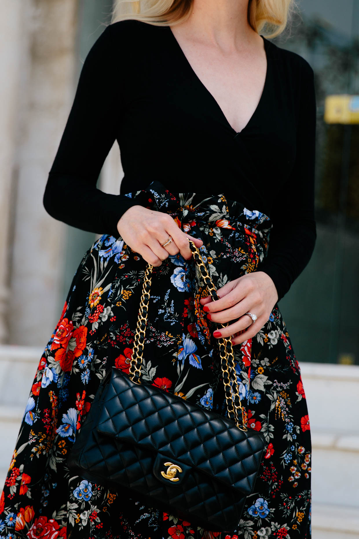Black bodysuit with floral print skirt and Chanel bag chic spring