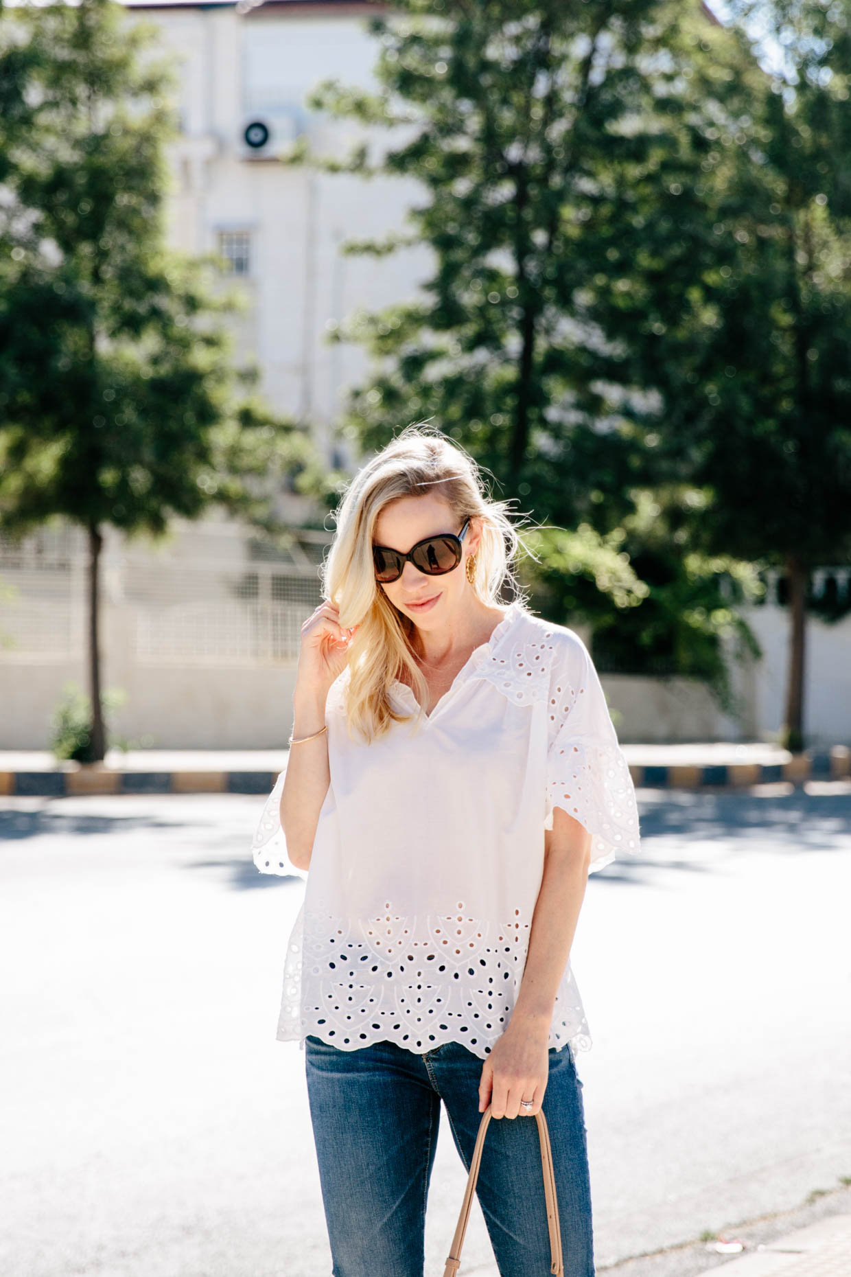 Cute white eyelet blouse for summer with Chanel sunglasses and dark denim -  Meagan's Moda