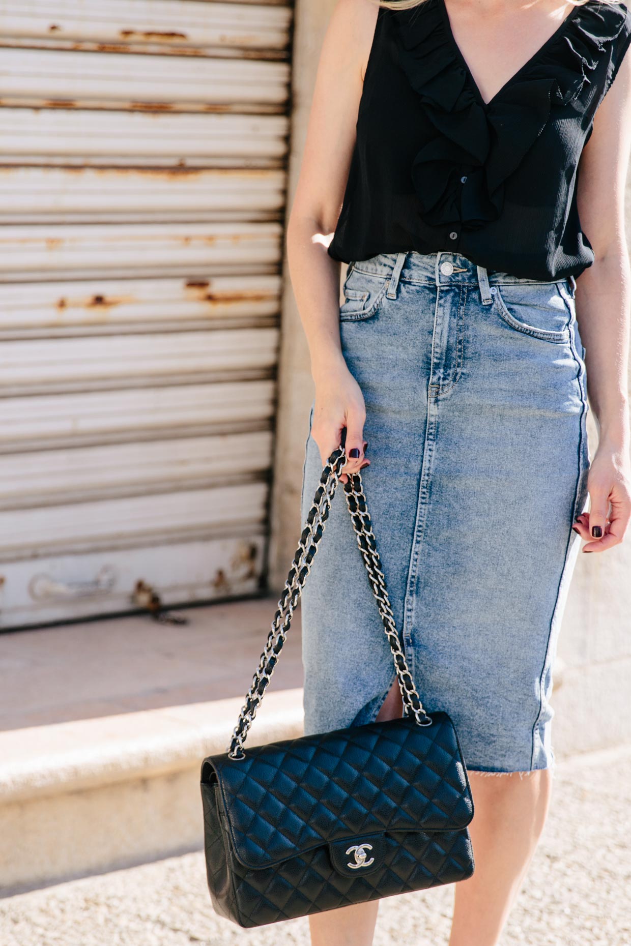Fall outfit idea with black ruffle blouse, denim midi skirt, and Chanel  Jumbo bag black caviar with silver hardware - Meagan's Moda