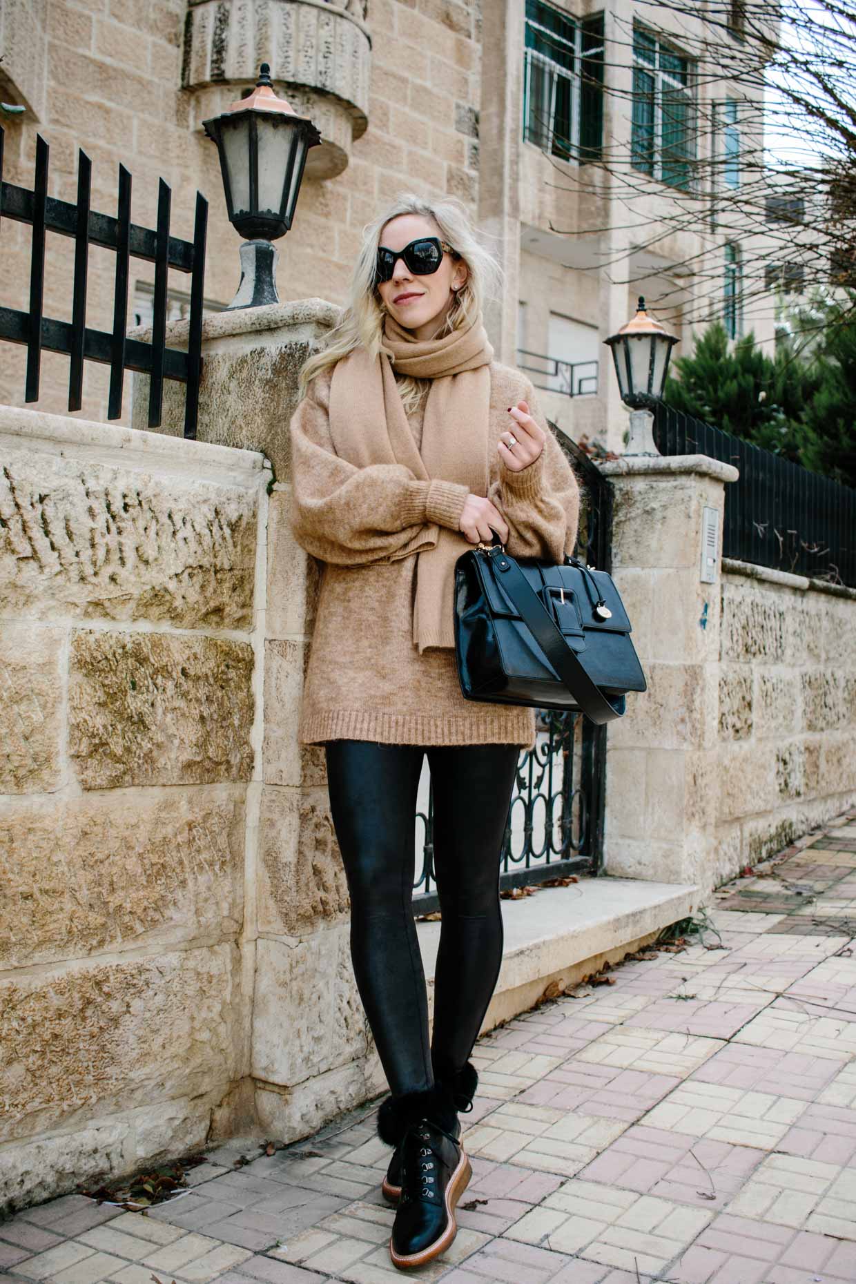 https://www.meagansmoda.com/wp-content/uploads/2019/01/Meagan-Brandon-fashion-blogger-of-Meagans-Moda-wears-oversized-camel-sweater-with-Spanx-faux-leather-leggings-best-faux-leather-leggings.jpg