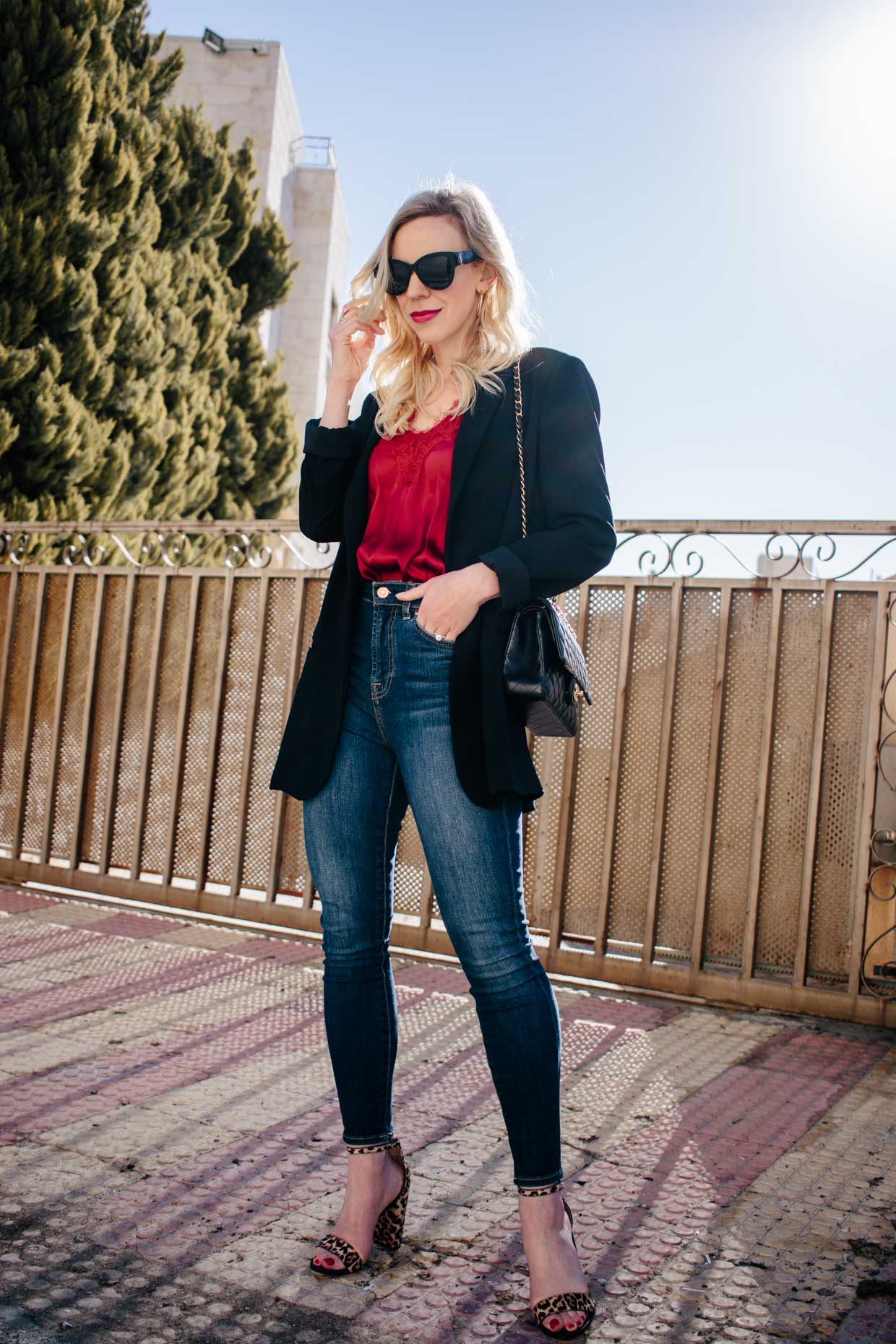 Meagan Brandon fashion blogger of Meagan's Moda shows leopard print  camisole outfit with black fluted midi skirt and red Saint Laurent high  school satchel - Meagan's Moda