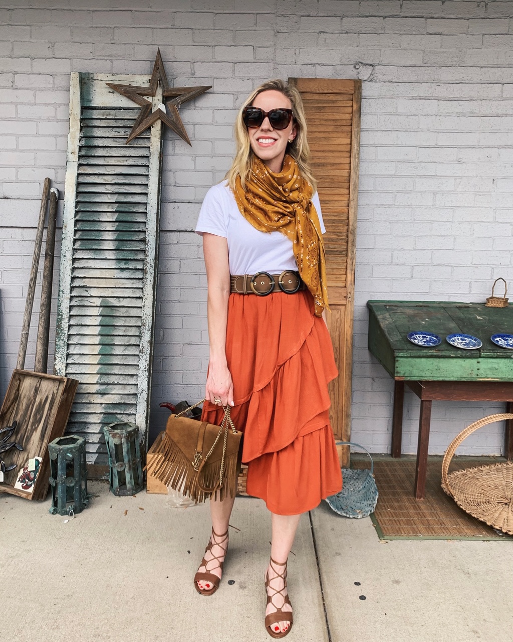 Meagan Brandon fashion blogger of Meagan's Moda shows how to wear and  orange skirt for summer with white tee and printed bandana scarf - Meagan's  Moda