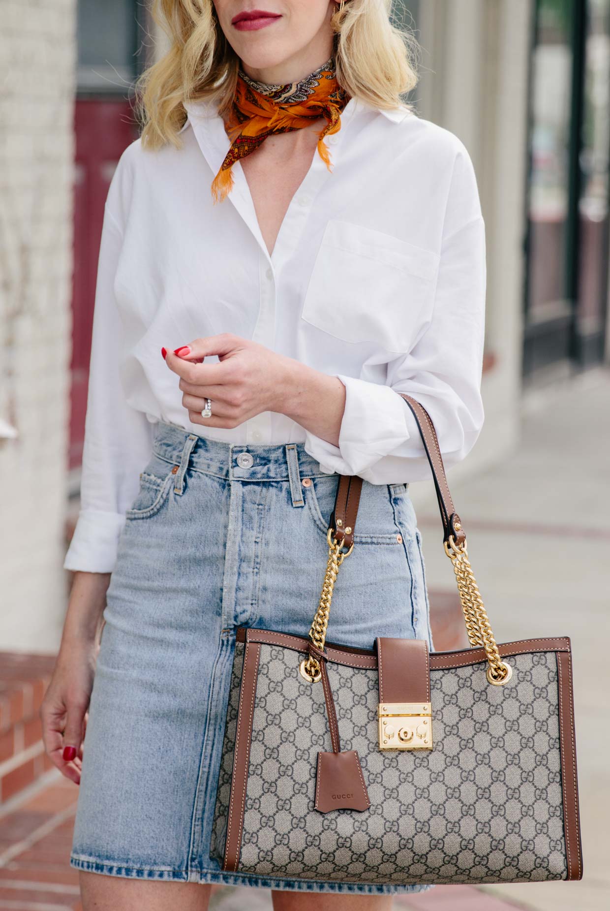 Meagan Brandon fashion blogger of Meagan's Moda wears chic denim skirt  outfit with white button down shirt, neck scarf and Gucci GG Supreme tote -  Meagan's Moda