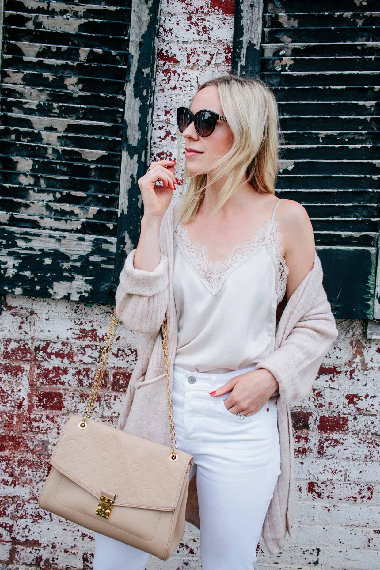 Meagan Brandon fashion blogger of Meagan's Moda shows how to wear all white  for fall with beige cardigan, cream lace camisole and white denim - Meagan's  Moda