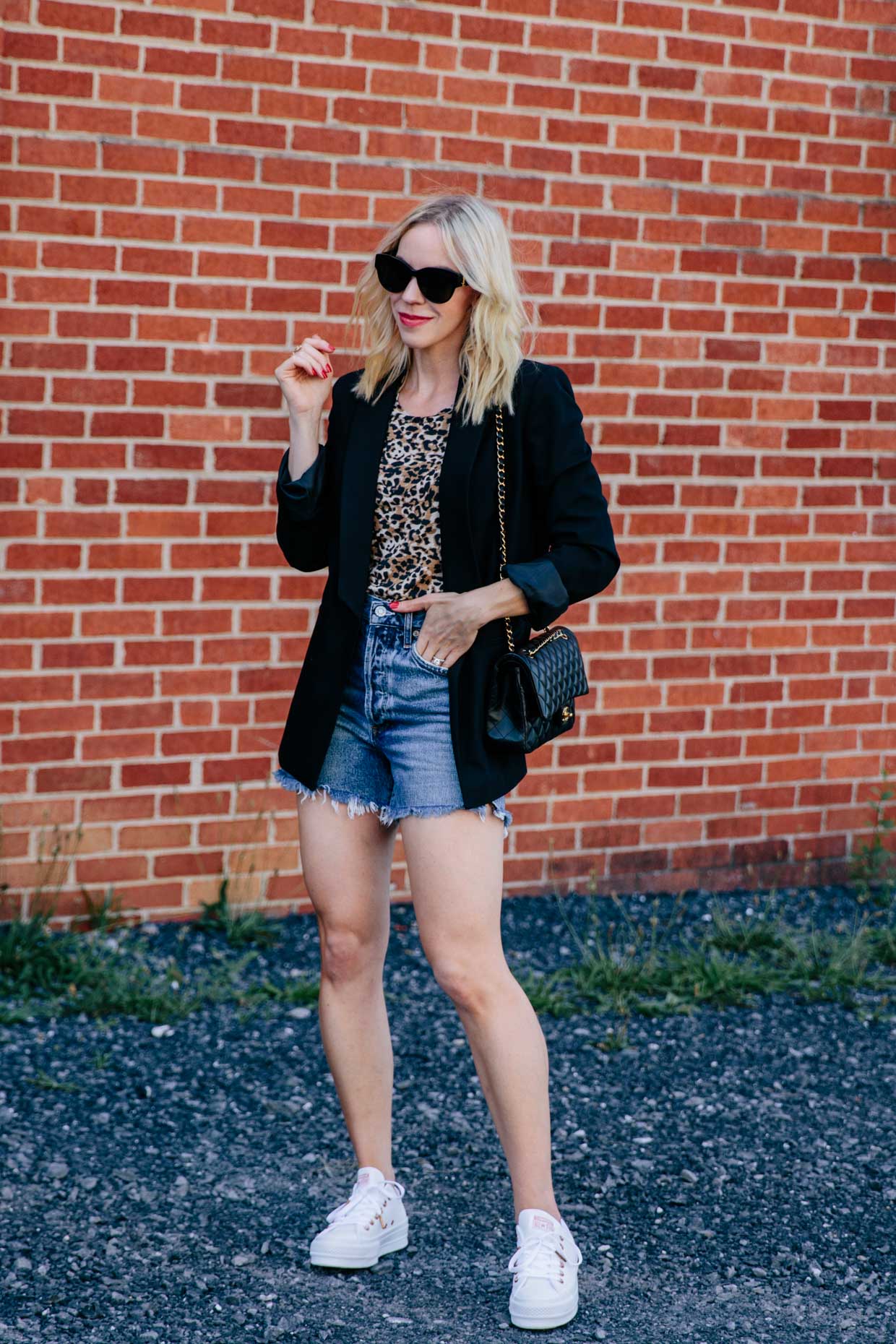 Meagan Brandon fashion blogger of Meagan's Moda wears black blazer with leopard tee, denim shorts and white sneakers