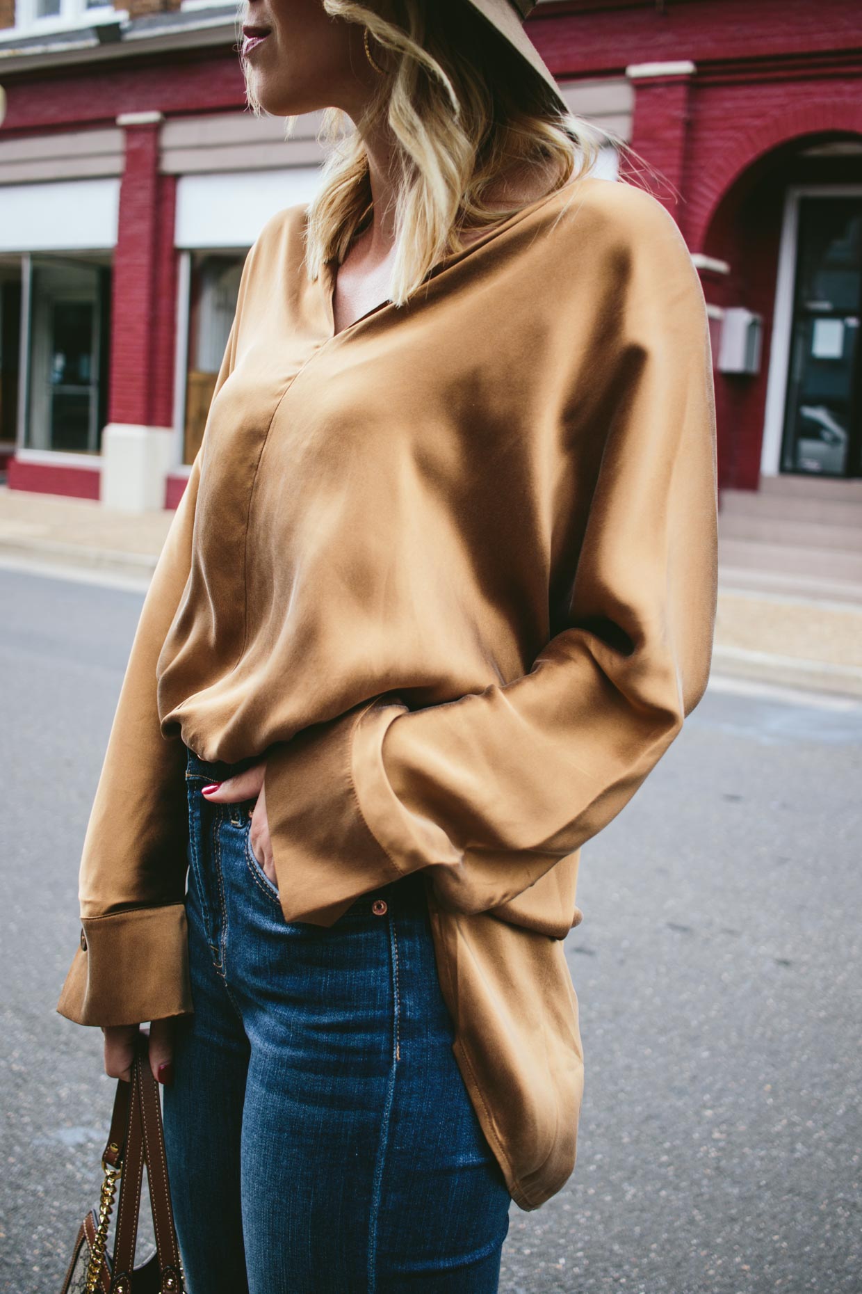 Meagan Brandon fashion blogger Meagan's Moda wears rust brown oversized silk shirt H&M with high waist denim for fall outfit idea - Moda