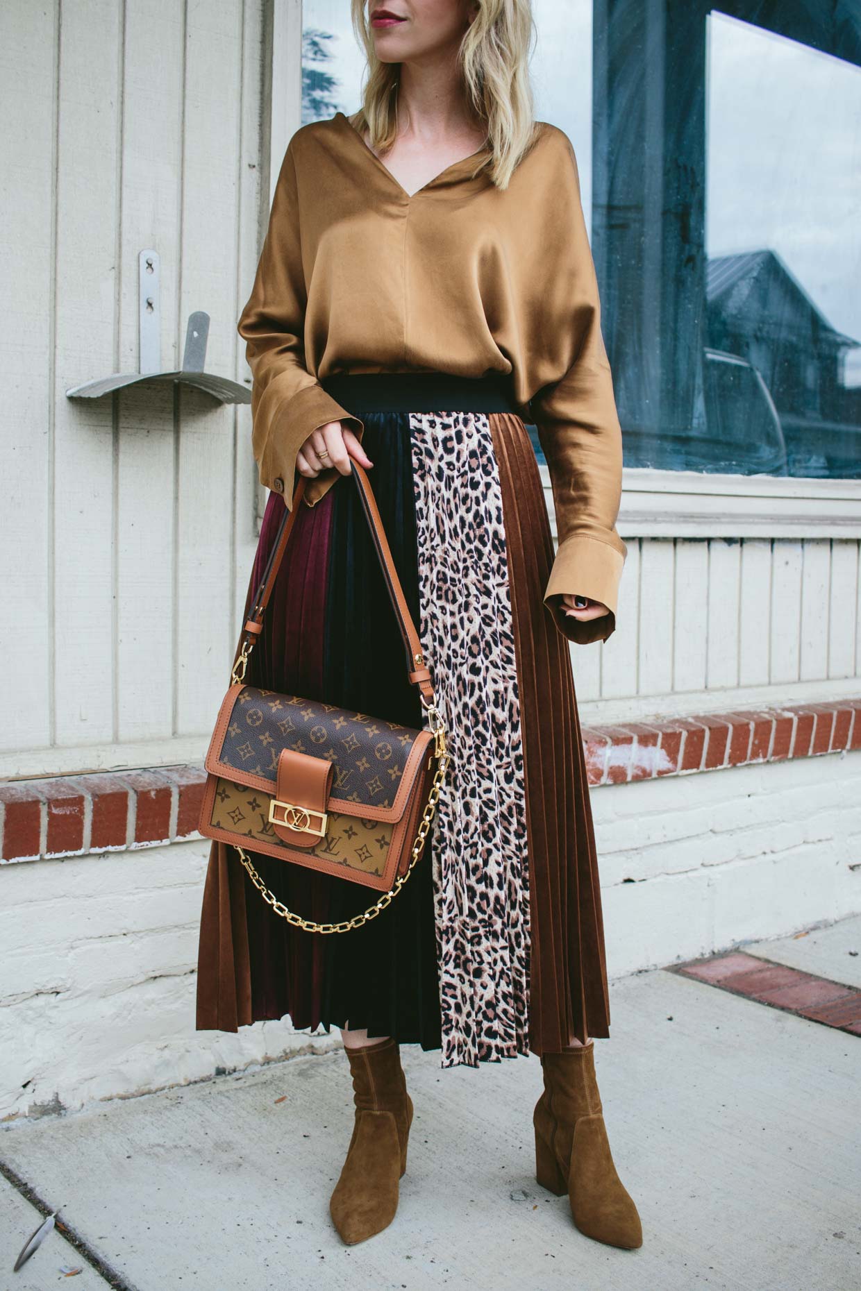 Meagan Brandon fashion blogger of Meagan's Moda wears H&M rust brown silk  shirt with leopard print pleated skirt, brown suede booties and Louis  Vuitton Dauphine bag for chic fall outfit - Meagan's