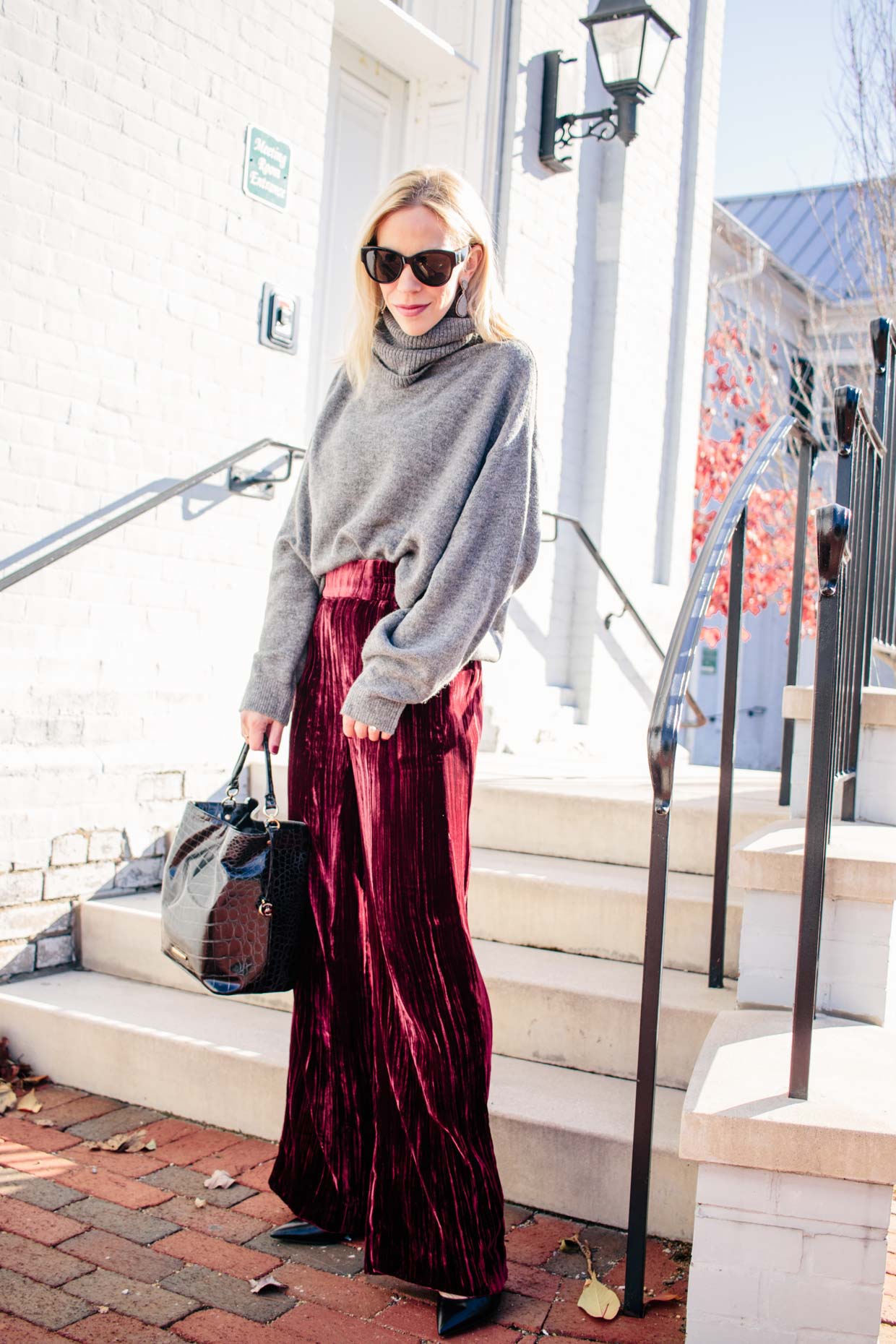 Meagan Brandon fashion blogger of Meagan's Moda wears gray oversized  turtleneck sweater with red velvet pants for chic cozy holiday outfit -  Meagan's Moda