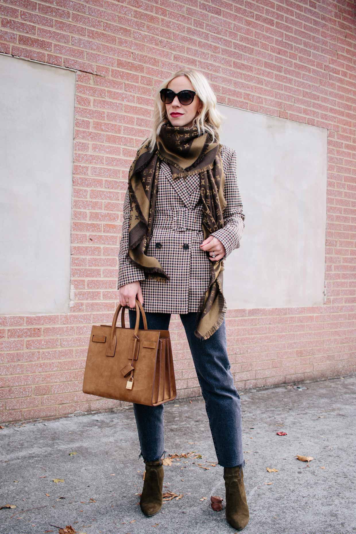 Meagan Brandon fashion blogger of Meagan's Moda wears Louis Vuitton brown monogram  shine shawl scarf with plaid blazer for chic fall outfit - Meagan's Moda