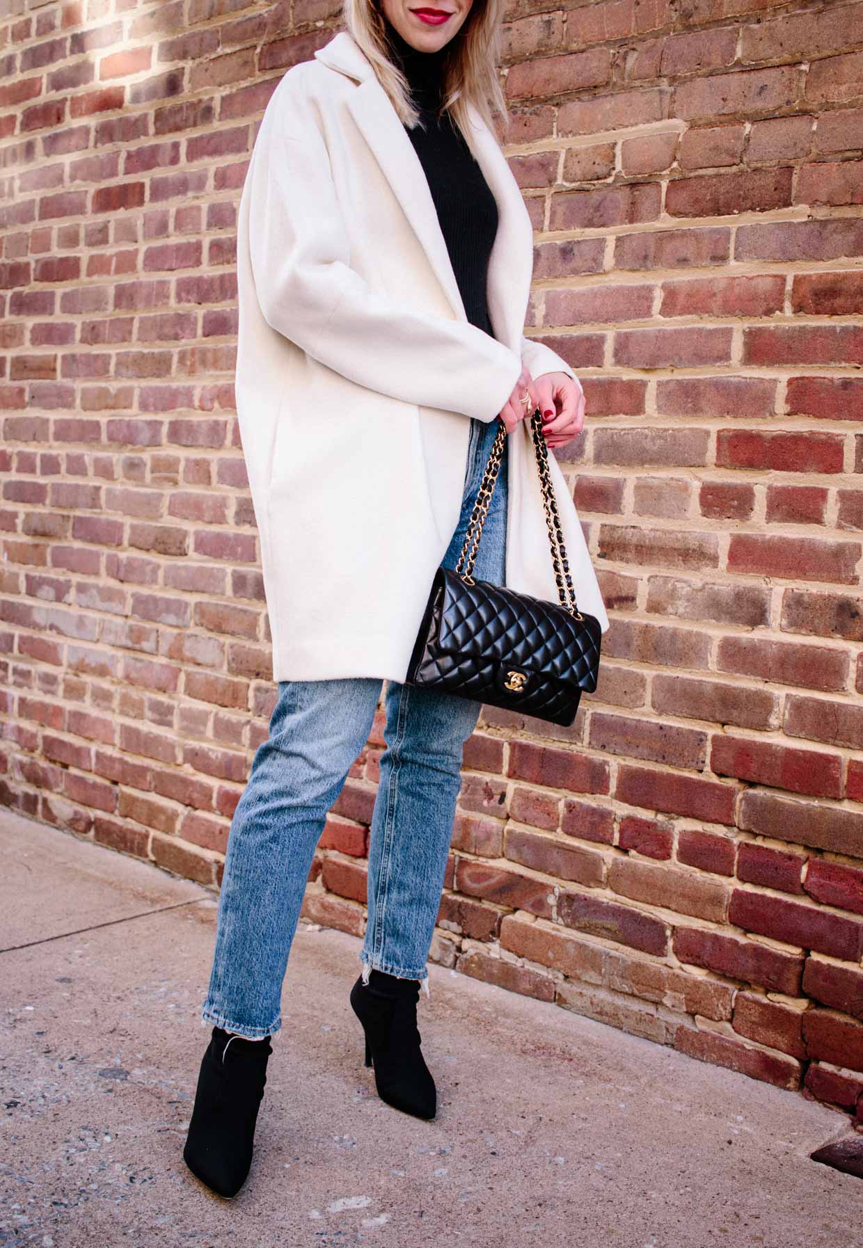Meagan Brandon fashion blogger of Meagan's Moda shows how to wear an  oversized white coat for winter with bodysuit and straight leg cropped  jeans - Meagan's Moda