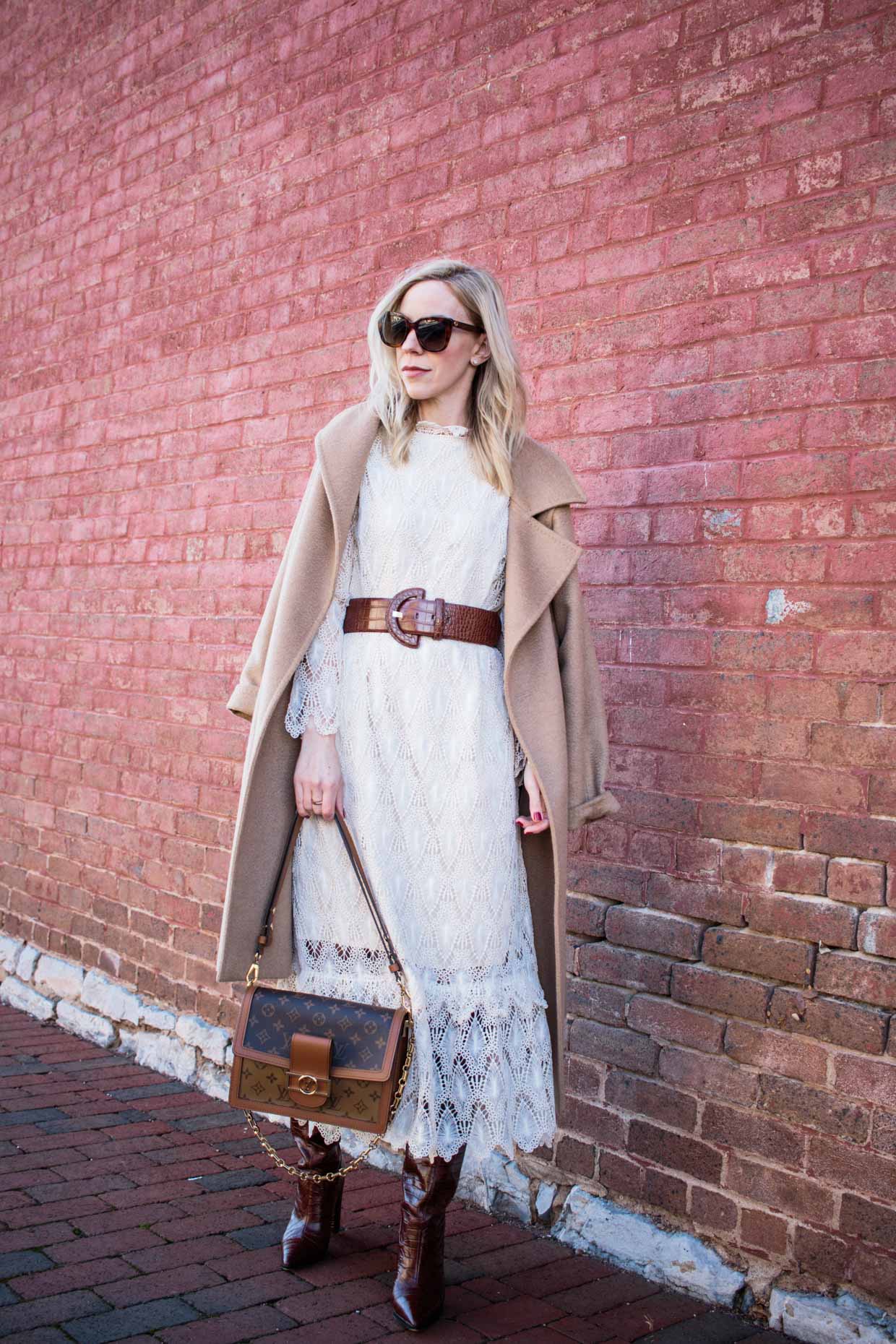 Meagan Brandon fashion blogger of Meagan's Moda shows how to wear a midi dress with a wide waist belt and camel coat