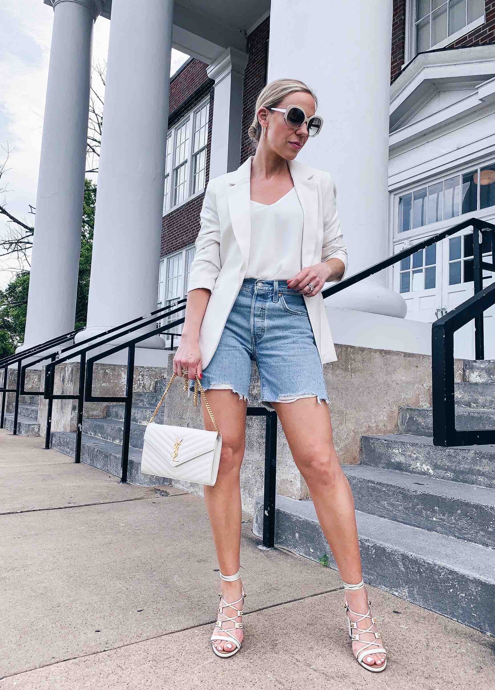 Meagan Brandon fashion blogger of Meagan's Moda wears white blazer with Levi's  mid length denim shorts and Valentino Rockstud white sandals - Meagan's Moda