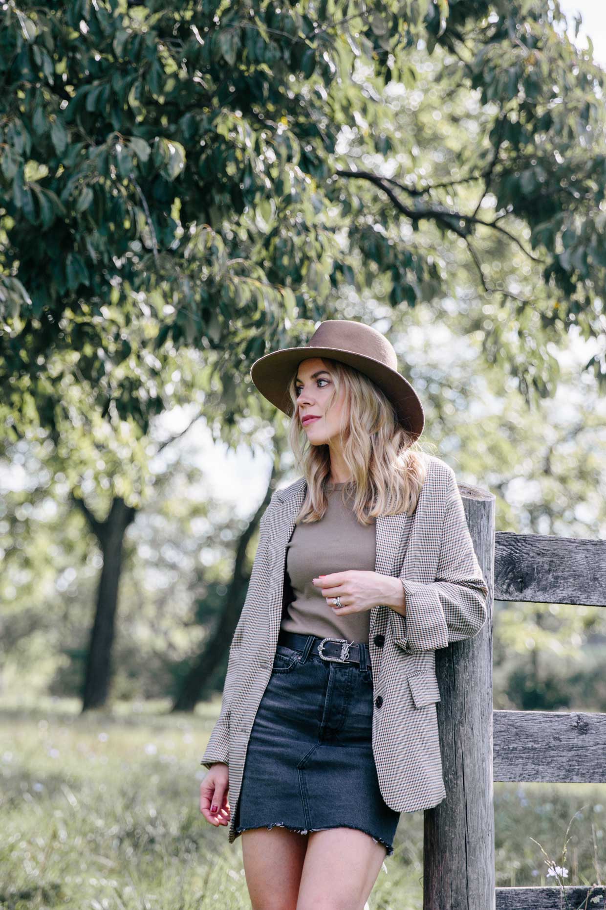 Meagan Brandon fashion blogger of Meagan's Moda wears Janessa Leone Billie  fedora with camel sweater, Madewell black denim skirt and Louis Vuitton brown  monogram shine shawl for chic layered fall outfit 