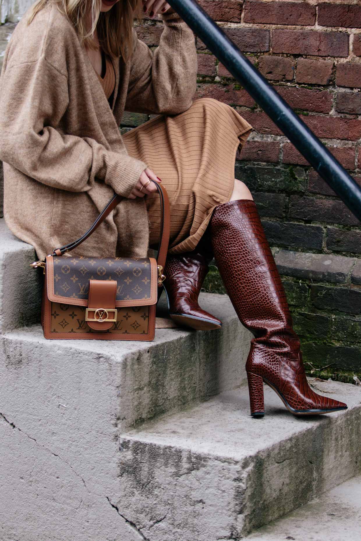 Meagan Brandon fashion blogger of Meagan's Moda wears rust colored poncho  with leather mini skirt, croc knee high boots and Louis Vuitton Dauphine -  Meagan's Moda