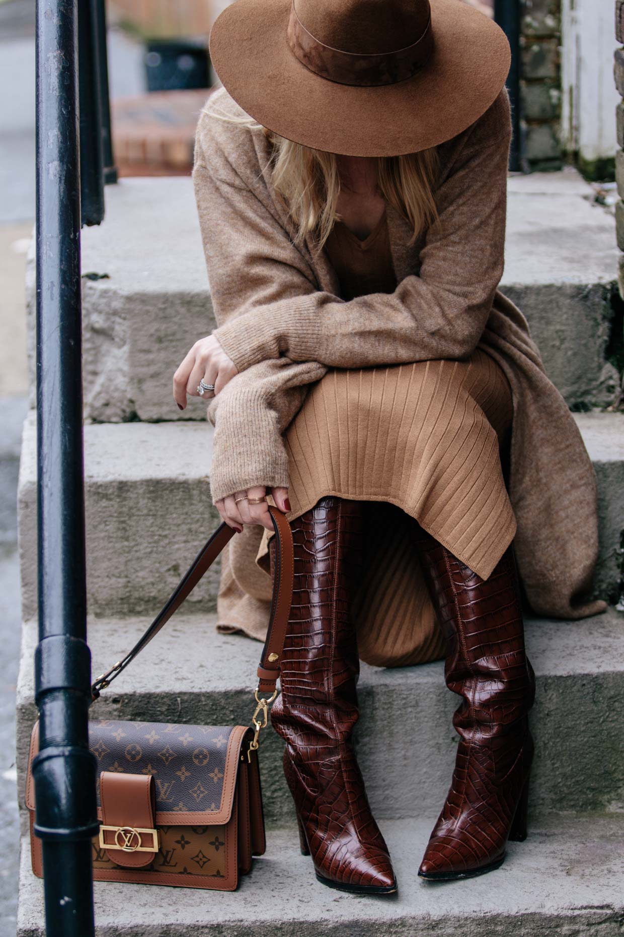 Meagan Brandon fashion blogger of Meagan's Moda wears Janessa Leone Billie  fedora with camel sweater, Madewell black denim skirt and Louis Vuitton brown  monogram shine shawl for chic layered fall outfit 