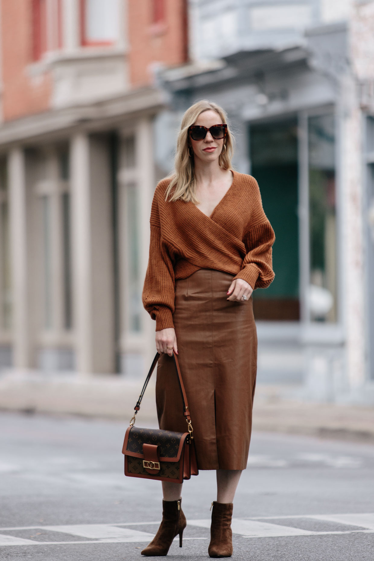 Chic layered fall outfit idea with camel sweater, black denim skirt and  Louis Vuitton brown monogram shine shawl scarf - Meagan's Moda