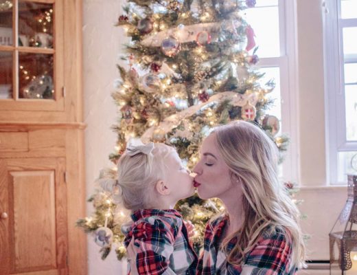 Meagan Brandon fashion blogger of Meagan's Moda wears matching Christmas family pajamas from Old Navy with toddler daughter tartan plaid family pajamas