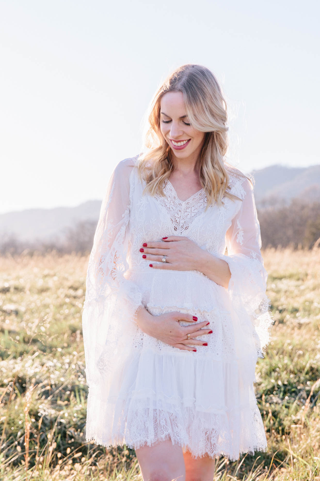 Meagan Brandon fashion blogger of Meagan's Moda wears Chicwish white bell sleeve dress for maternity announcement photo shoot