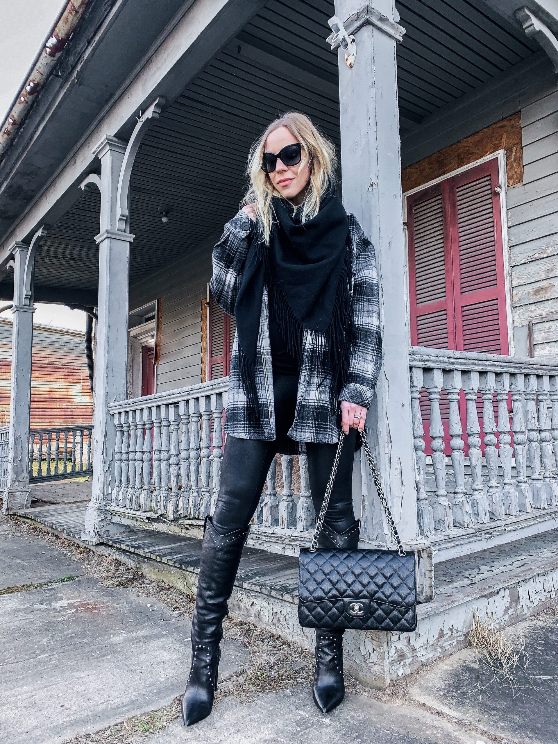 Meagan Brandon fashion blogger of Meagan's Moda wears Louis Vuitton black  shine shawl with leather moto jacket, gray high waist jeans and Marc Fisher  black Chelsea boots black and gray outfit 