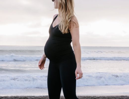 Meagan Brandon fashion blogger of Meagan's Moda wears BLANQI maternity cropped leggings and crossback tank, best maternity active wear