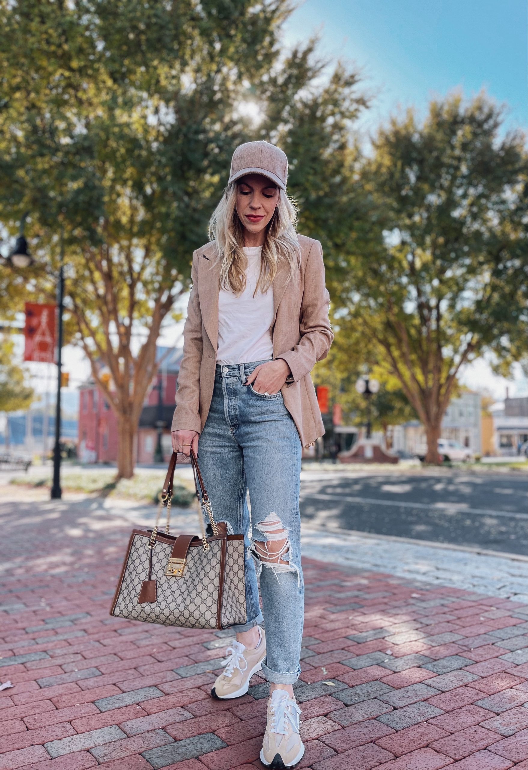 Meagan Brandon of Meagan's Moda wears camel blazer with jeans and New Balance 327 sneakers, how to wear New Balance 327 sneakers